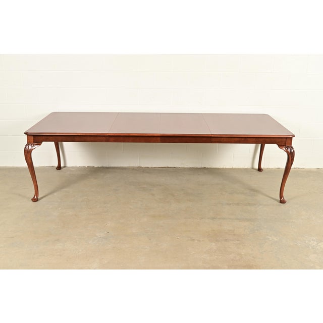 A gorgeous Queen Anne or Georgian style extension dining table By Baker Furniture USA, Circa 1980s Gorgeous book-matched...