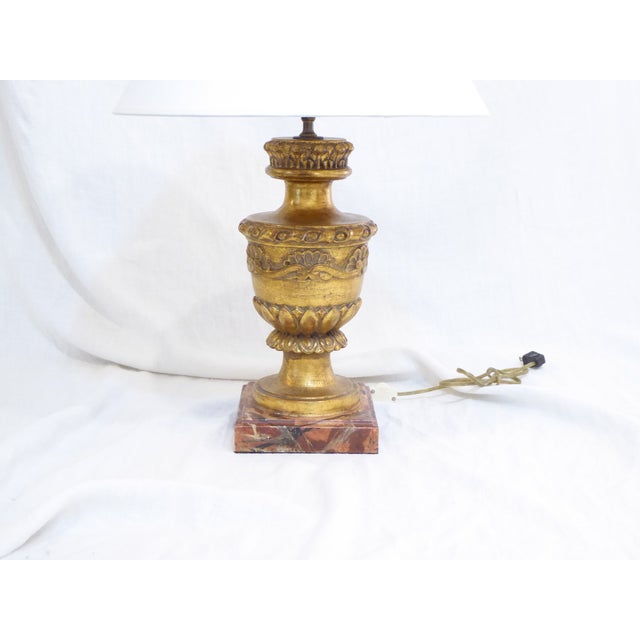 This Florentine carved giltwood lamp comes with a simple white paper shade, 16"Diameter. Use up to 100 Watt Edison base bulb.