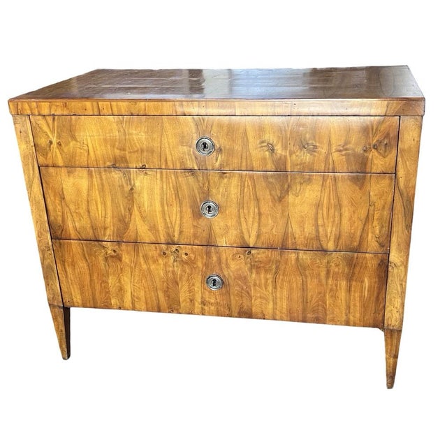 Neoclassical commode hand-made in central Italy in the early 1800s using elm wood and decorated with book-matched elm wood...