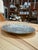 A sculptural decorative dish featuring an irregular rounded silhouette and a richly textured surface reminiscent of...