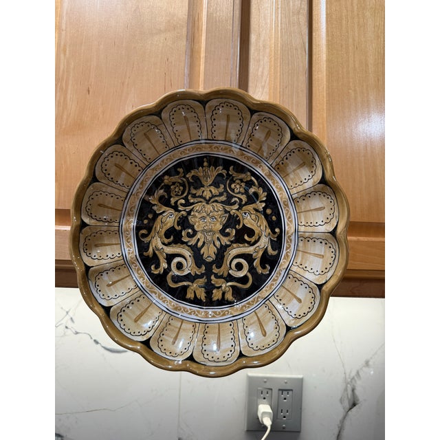 The item in the image is a stunning, hand-painted ceramic bowl from Deruta, Italy, which is historically renowned as a...
