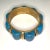 This is part of Chairish’s Costume Jewelry assortment. Vintage turquoise and brass chunky bangle. Styled after Native...