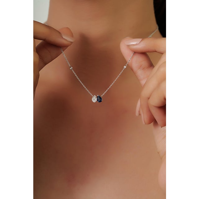 This elegant pendant necklace features a 0.52 carat pear-cut blue sapphire set in 14K white gold. The sapphire measuring...