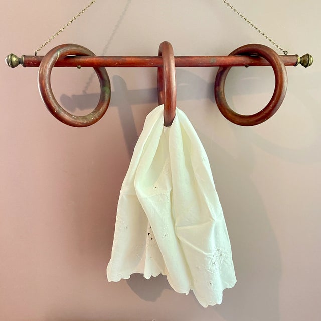 From the Belle Epoque Era, a unique hanging Three Ring Fruit Wood and Brass Towel Rack, France, circa 1880-1900. A long...
