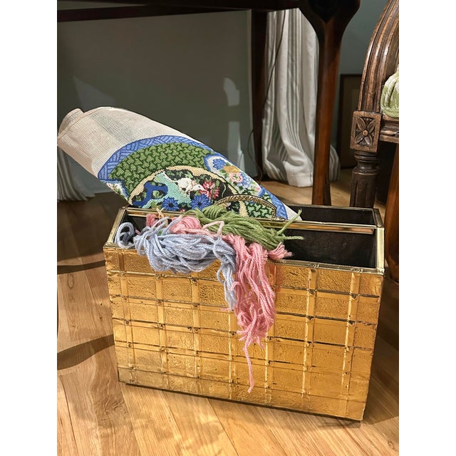 This magazine rack hails from the !970's, probably from England, and is wood clad in brass. The brass has a rippled almost...