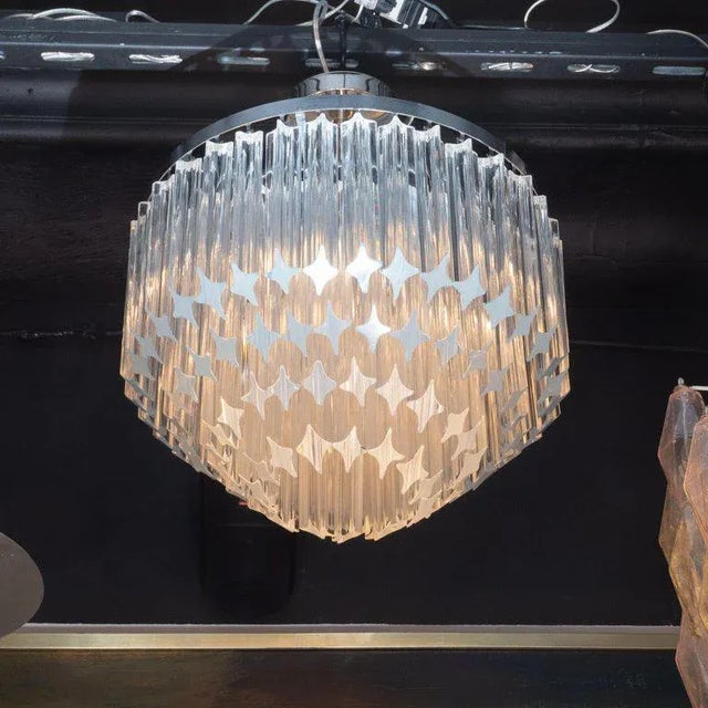 This refined chandelier was realized in Italy, circa 1970. It features an abundance of camer crystals hanging from...