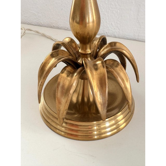 Unusual, chic little table lamp, made in Italy in the 70s. The lamp base is made of solid brass and has a ring of brass...