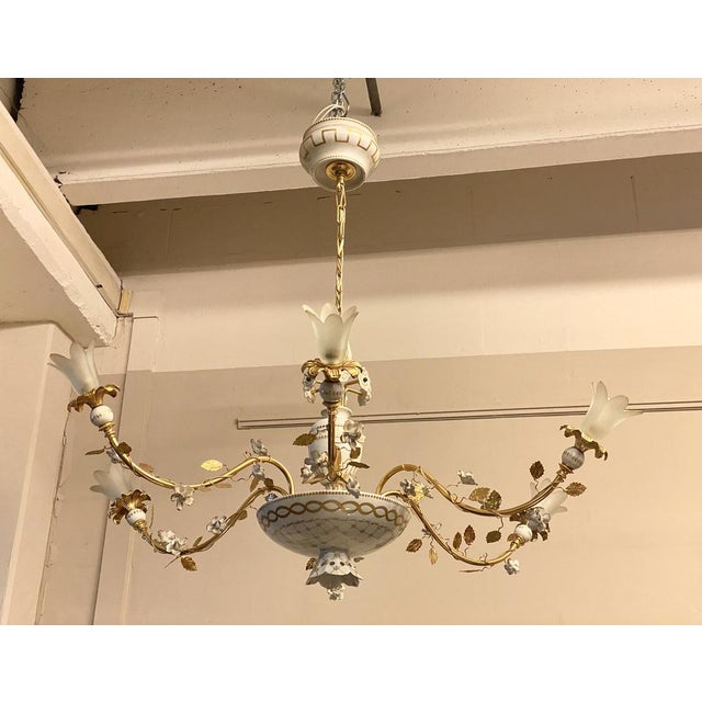 Pair of chandeliers produced by the Mangani company of Florence, porcelain painted with golden applications, golden metal...