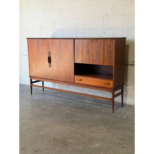 This expansive sideboard features a striking minimalist profile elevated on a refined leg base. The clever layout includes...