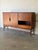 This expansive sideboard features a striking minimalist profile elevated on a refined leg base. The clever layout includes...