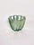 A 1940s Art Deco ashtray crafted from thick molded glass in a nuanced green hue. Its circular form is punctuated by...