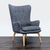 This West Elm lounge chair features a modern high-back design with button-tufted detailing and comfortable armrests. The...