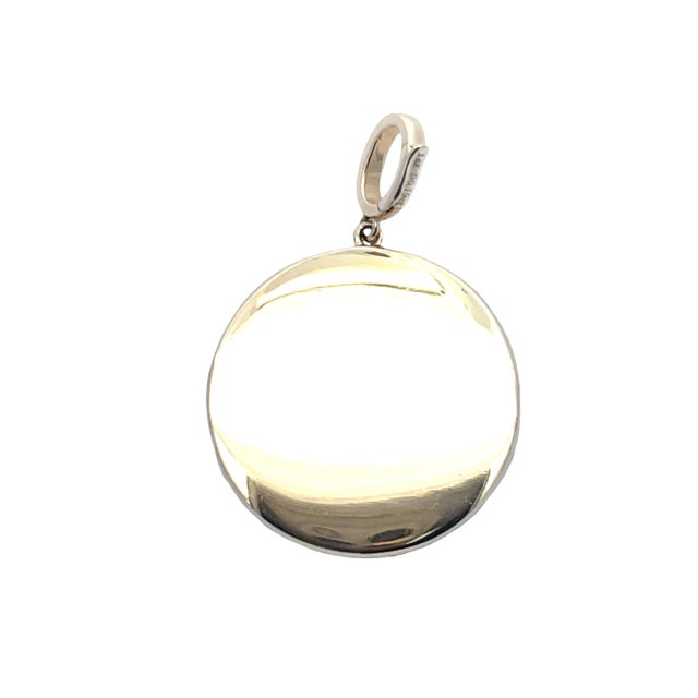 Striking 14K yellow gold Gemini zodiac charm featuring a textured round medallion with twin-figure motif, accented by...