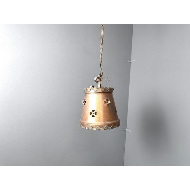 Vintage brutalist hammered copper sheet pendant light. The lamp emits a nice diffuse light thanks to the perforated shade....
