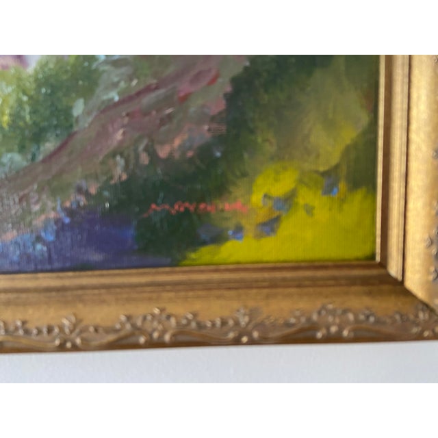 A barn and silo is nestled in the luxuriant field of green and gold. Pink clous billow in a blue sky. The lovely view is...