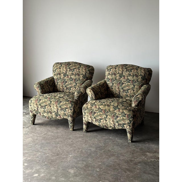 Wrapped edge to edge in a dense acanthus leaf tapestry, this pair of vintage club chairs carries real presence in a room....