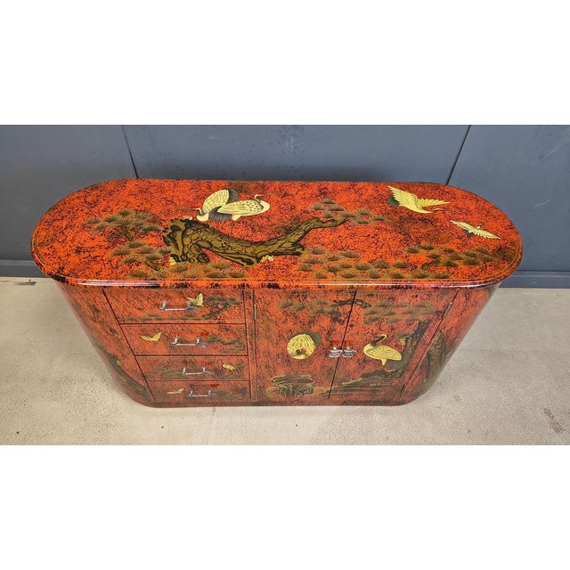 Striking red chinoiserie cabinet consisting of two doors and four drawers. Notice the cool cuttlery shaped handles on the...