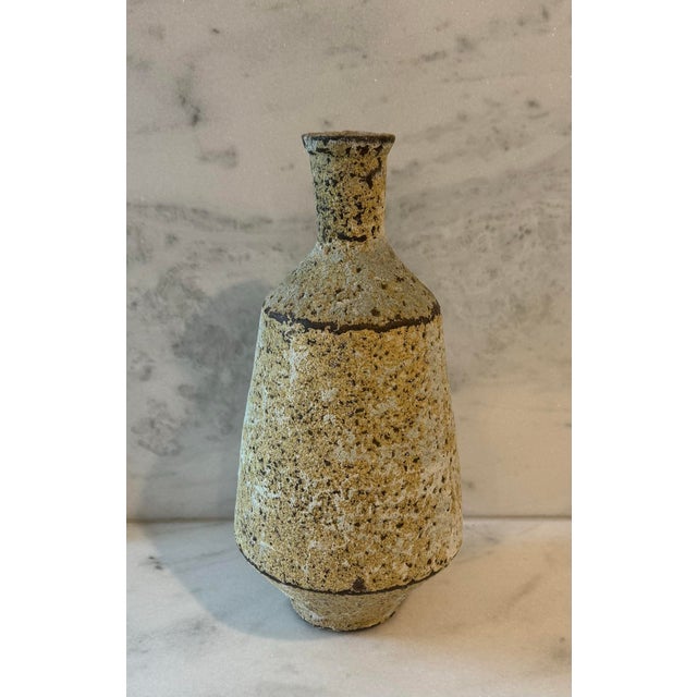 Rustic mid century artisan studio pottery tapered vase with a lava like textured finish in a modeled yellow, cream, green...