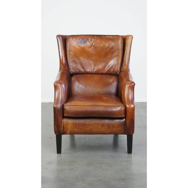 We are offering this timeless sheepskin armchair in good condition, with beautiful warm colors and excellent seating...