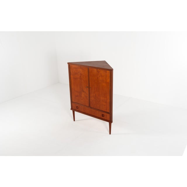 A lovely Danish corner cabinet from the 1960s with two doors and a drawer below. Designed to fit neatly into a corner, it...