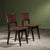 Pair of dining chairs by Jens Risom, made in the 1940s–1950s, features a frame in dark-stained solid oak with brass nails....