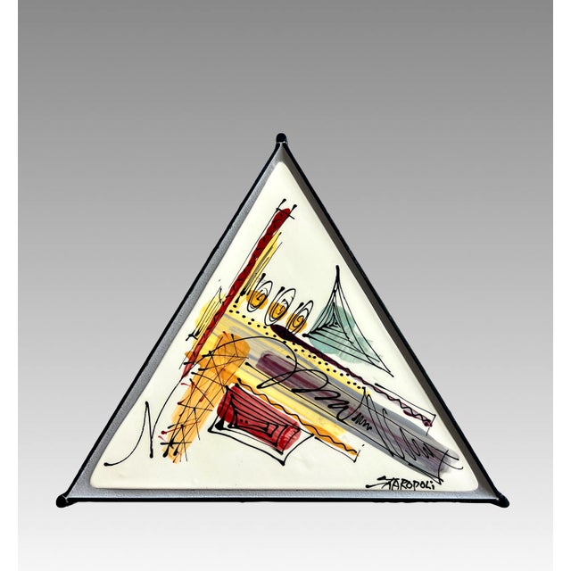 A rare and useful triangular Italian side table with stylish wavy wrought iron legs. Abstract & colourful enamel work...