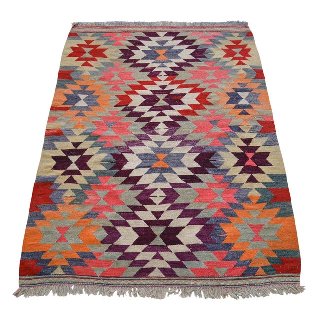 This authentic 1950s Mediterranean Anatolian kilim features a vibrant geometric design in deep plum, orange, and cream,...
