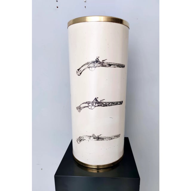 Made in Italy, 1950s - 1960s. This umbrella stand is made in brass and varnished and serigraphed metal with the...