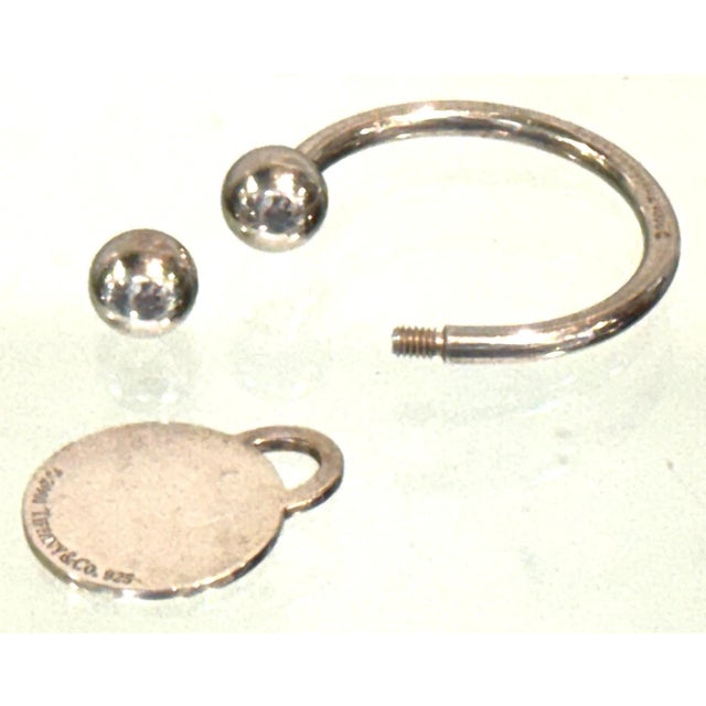 Tiffany & Co. Extra Large Sterling Silver Round Tag Screwball Key Ring, Dated 2001 Dimensions: 2.5" h with tag x 1.5" W x...