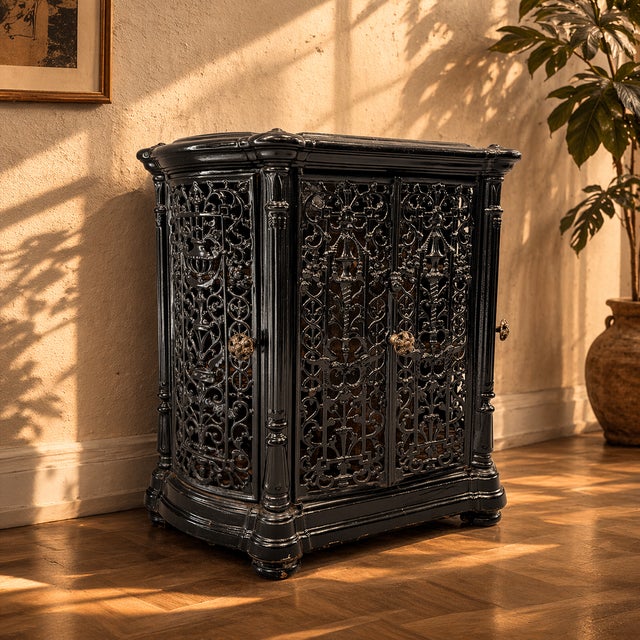 A richly detailed antique cast iron fireplace insert with intricate openwork and a deep black finish. A statement piece...