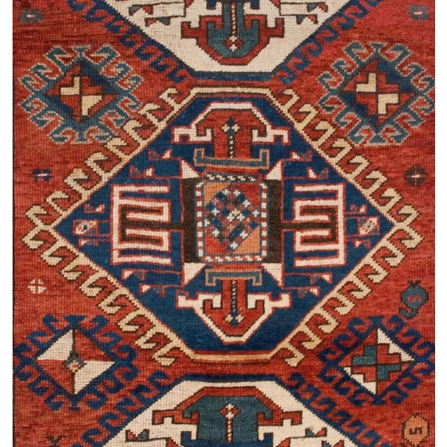A late 19th century Kazak rug with four wonderful diamond medallions on a crimson field of flowers with goats, surrounded...