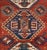 A late 19th century Kazak rug with four wonderful diamond medallions on a crimson field of flowers with goats, surrounded...
