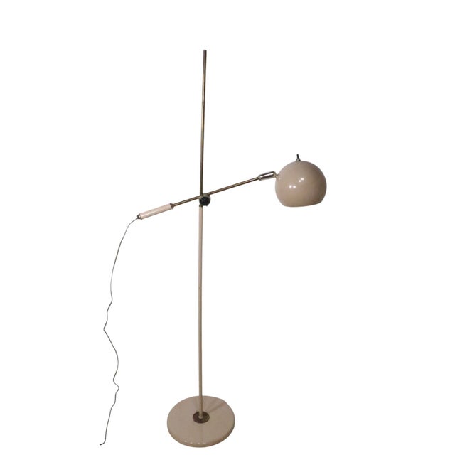 Iconic Eyeball form adjustable floor lamp, having an adjustable horizontal arm, with adjustable ball ( eyeball ) form hood...