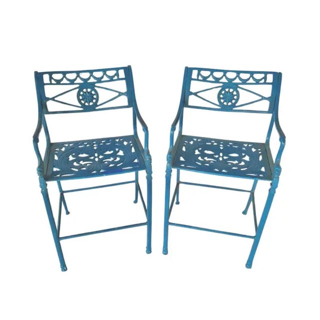 A Pair of Mid-20th Century Aluminum Barstools. Barstools feature an intricate pierced design with scrollwork and geometric...