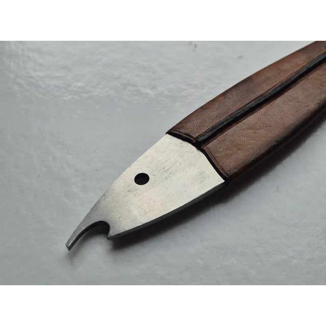 A classic Midcentury Modern fish-shaped bottle opener, made of stainless steel with dark-brown tan leather. Model #4687,...