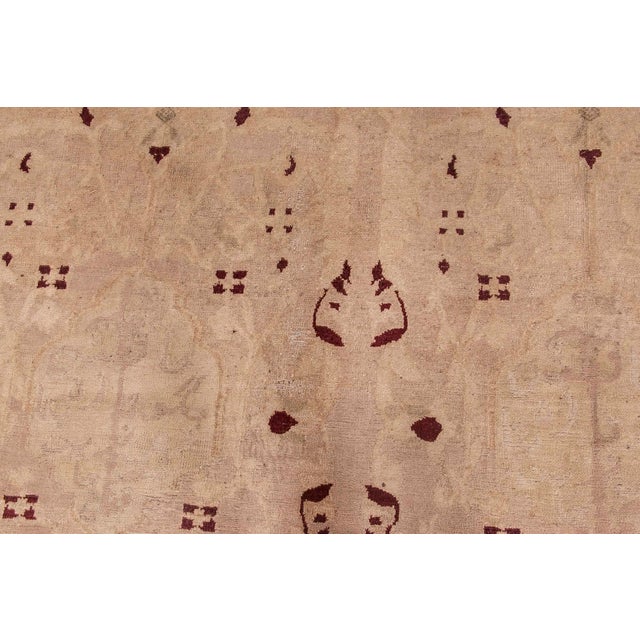 A late 19th century Indian Agra antique rug, the pale celadon and field with an allover subtle design of faint leafy vines...