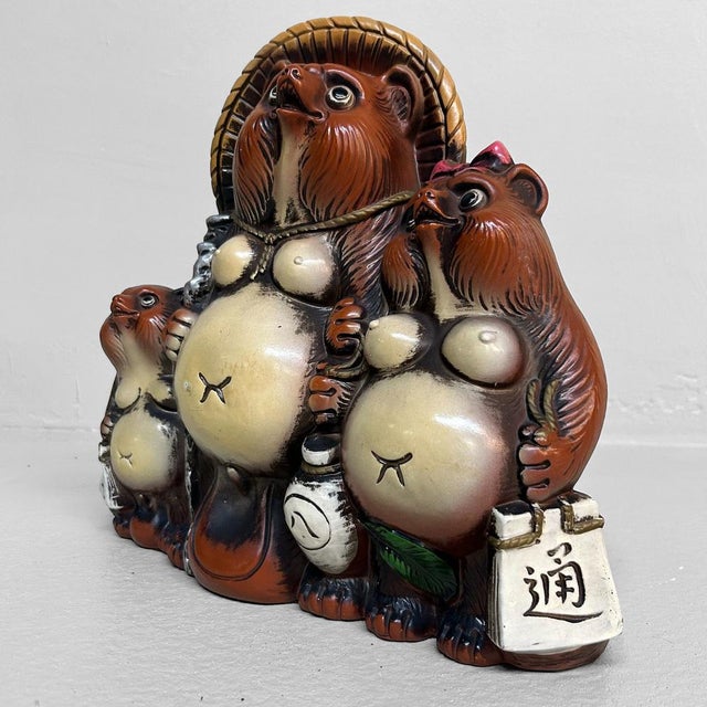 Cheerful statue of a tanuki family, crafted from plaster and hand-painted. This unique vintage piece from the 1980s-90s...