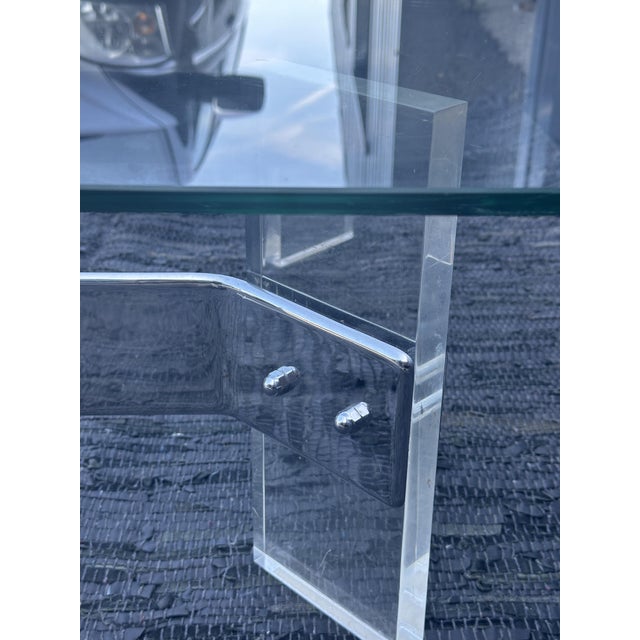 Coffee table in chromed metal and acrylic glass legs with a thickness of 2.5 CM, glass slab forming the top with a...