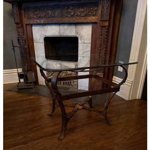 A striking equestrian-inspired side table in the manner of Jacques Adnet, featuring a sculptural iron base designed to...