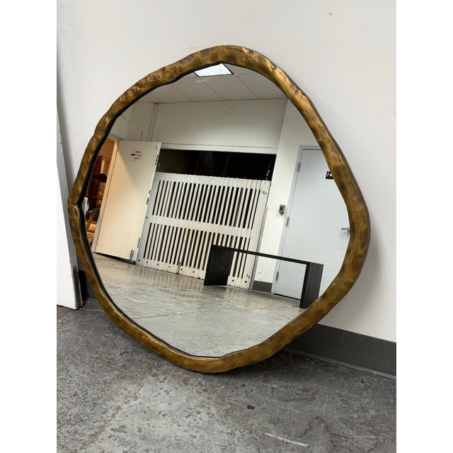 Design Plus Gallery presents the Abel Brass Round Wall Mirror by CB2. This mirror has an irregular round form with a...