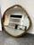 Design Plus Gallery presents the Abel Brass Round Wall Mirror by CB2. This mirror has an irregular round form with a...