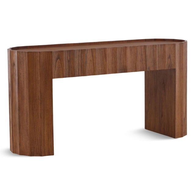 Rich brown Mindi wood console table with smooth scalloped design and rounded edges. Each may vary in exact coloring and...