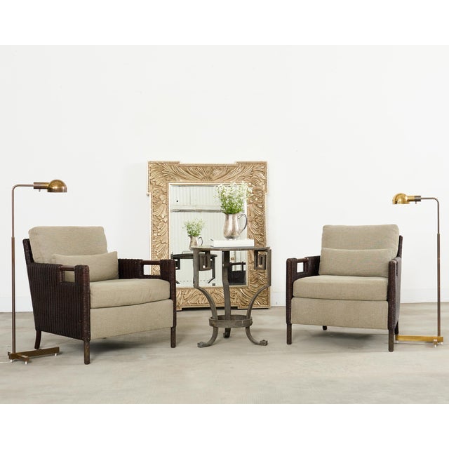 Patinated pair of signed mid-century modern brass pharmacy or floor lamps designed by Jon Norman for Casella Lighting. The...