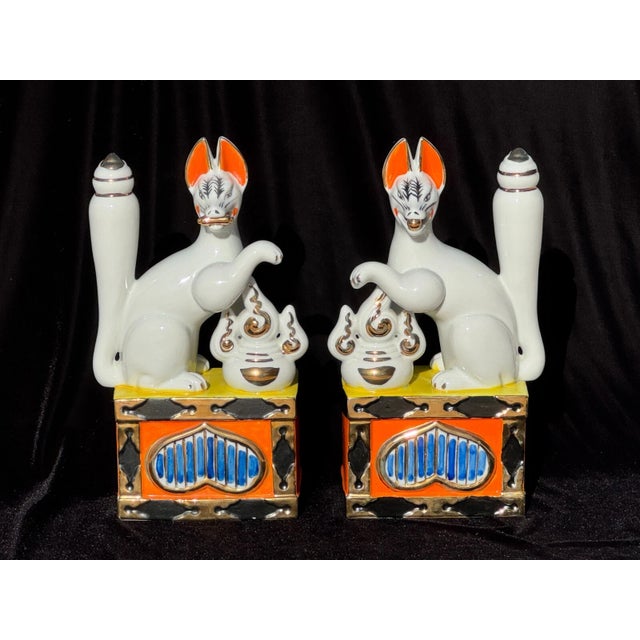 This commanding pair of large mid-century Japanese porcelain Inari fox statues presents a striking blend of traditional...
