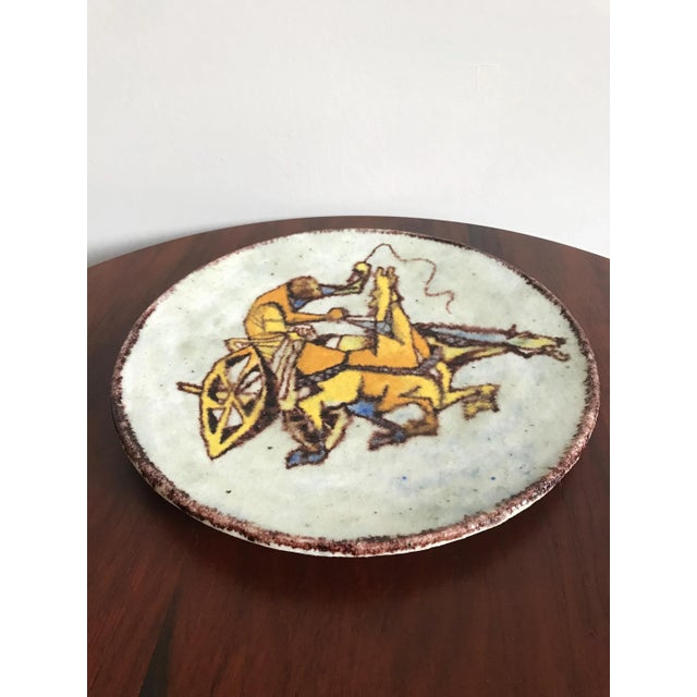 Cavetto decorative ceramic designed by the Italian artist Carlo Zauli decorated in polychrome with figure representation...