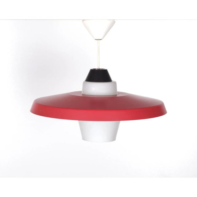 Very nice ceiling lamp. Red metal ring and comes with a Opaline glass shade . Typical Dutch design . Manufactured by...