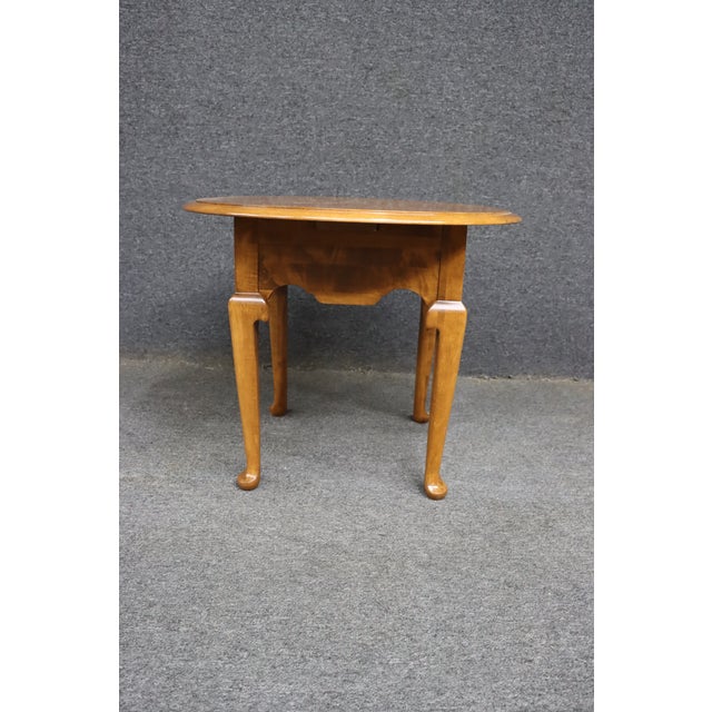 Classic Ethan Allen drop-leaf accent table featuring graceful Queen Anne styling with cabriole legs and a warm maple-toned...