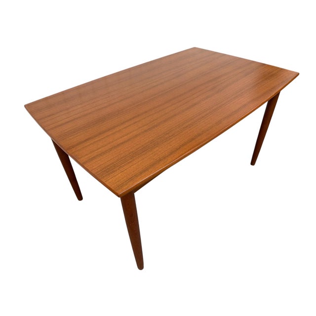 Bring timeless Scandinavian design to your dining space with this Mid-Century Danish Modern teak extension dining table,...