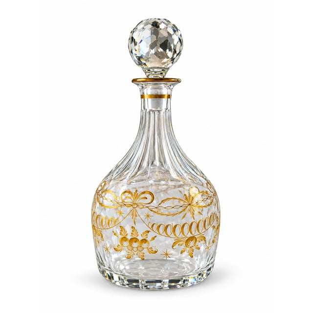 An elegant matching pair of crystal glass decanters featuring beautifully fluted bodies, intricate hand-painted floral and...