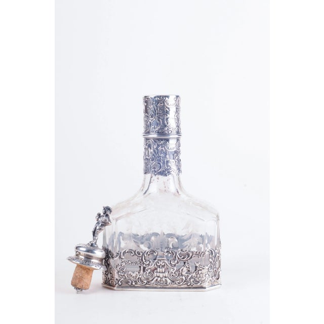 Storck & Sinsheimer (1874-1926). Hanau, Germany. Marked on bottom. Cut-glass decanter with reticulated base with pastoral...